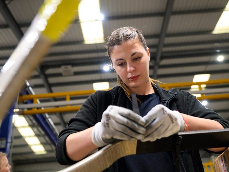 Skilled worker hand-taping insulation onto a diamond coil
